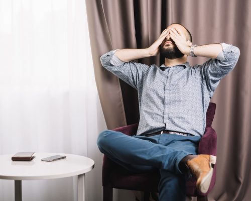 exhausted-man-sitting-armchair (1)